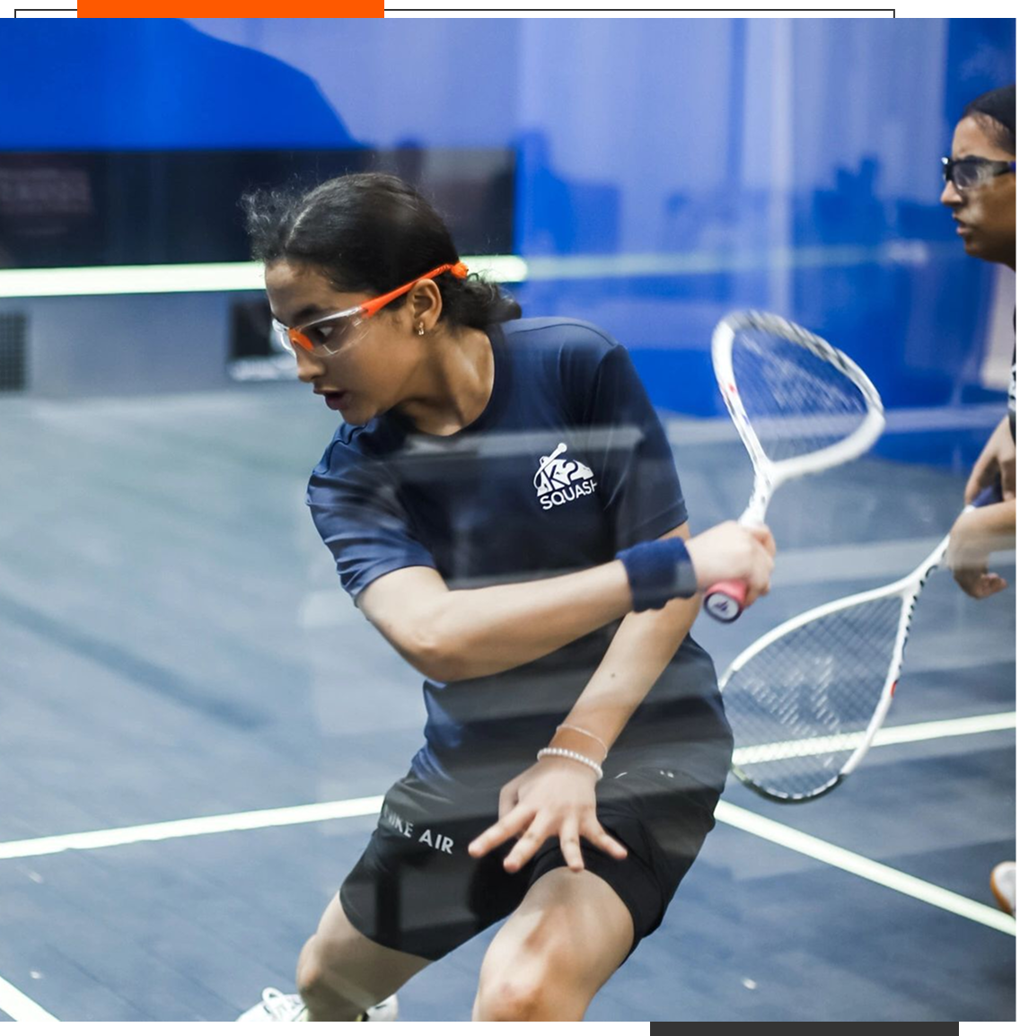 Two players competing in a squash match.