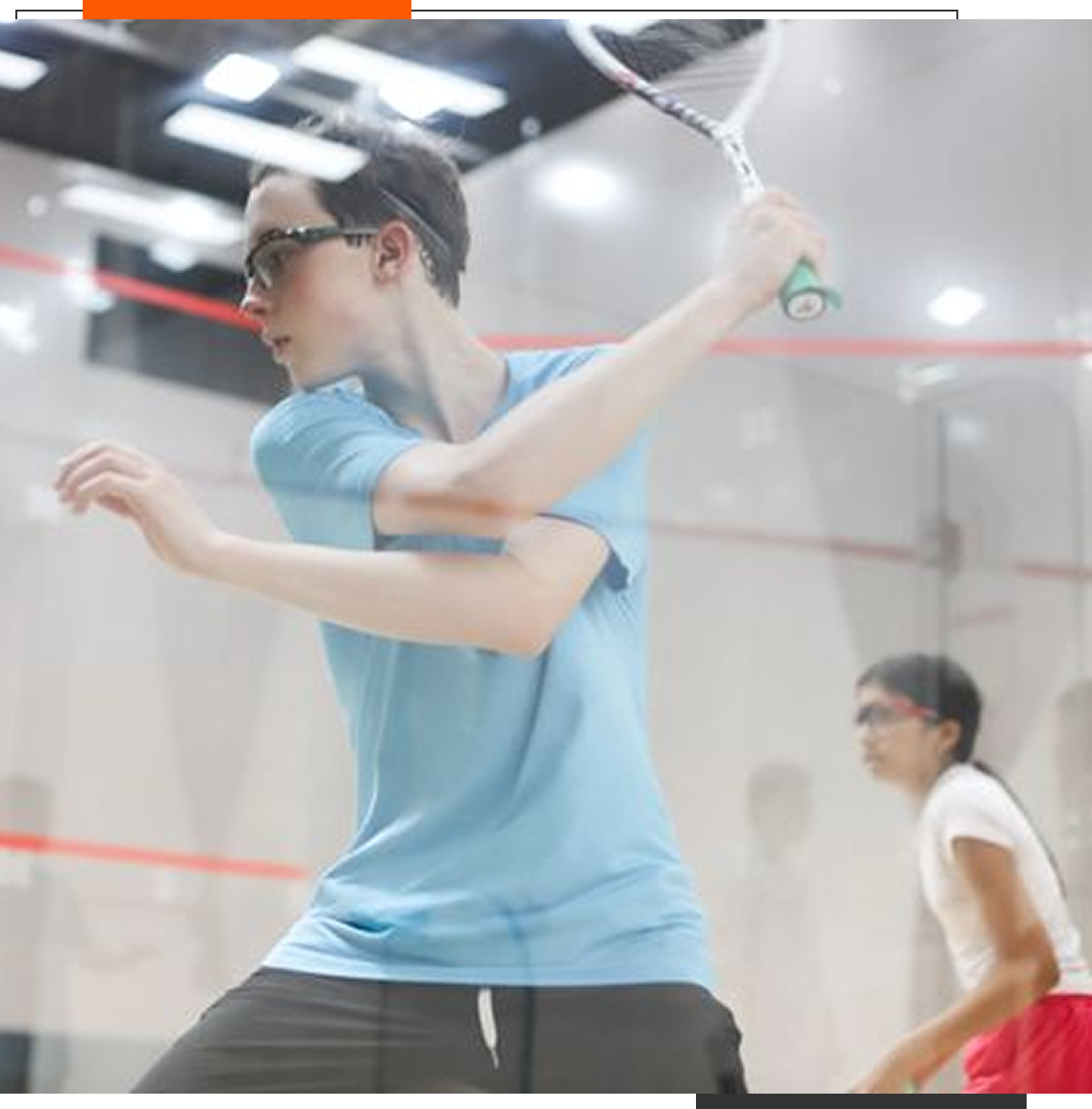 Two people playing squash on indoor court.