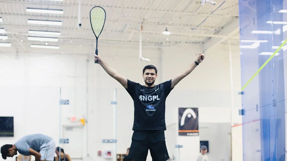 Squash player celebrating victory on court.