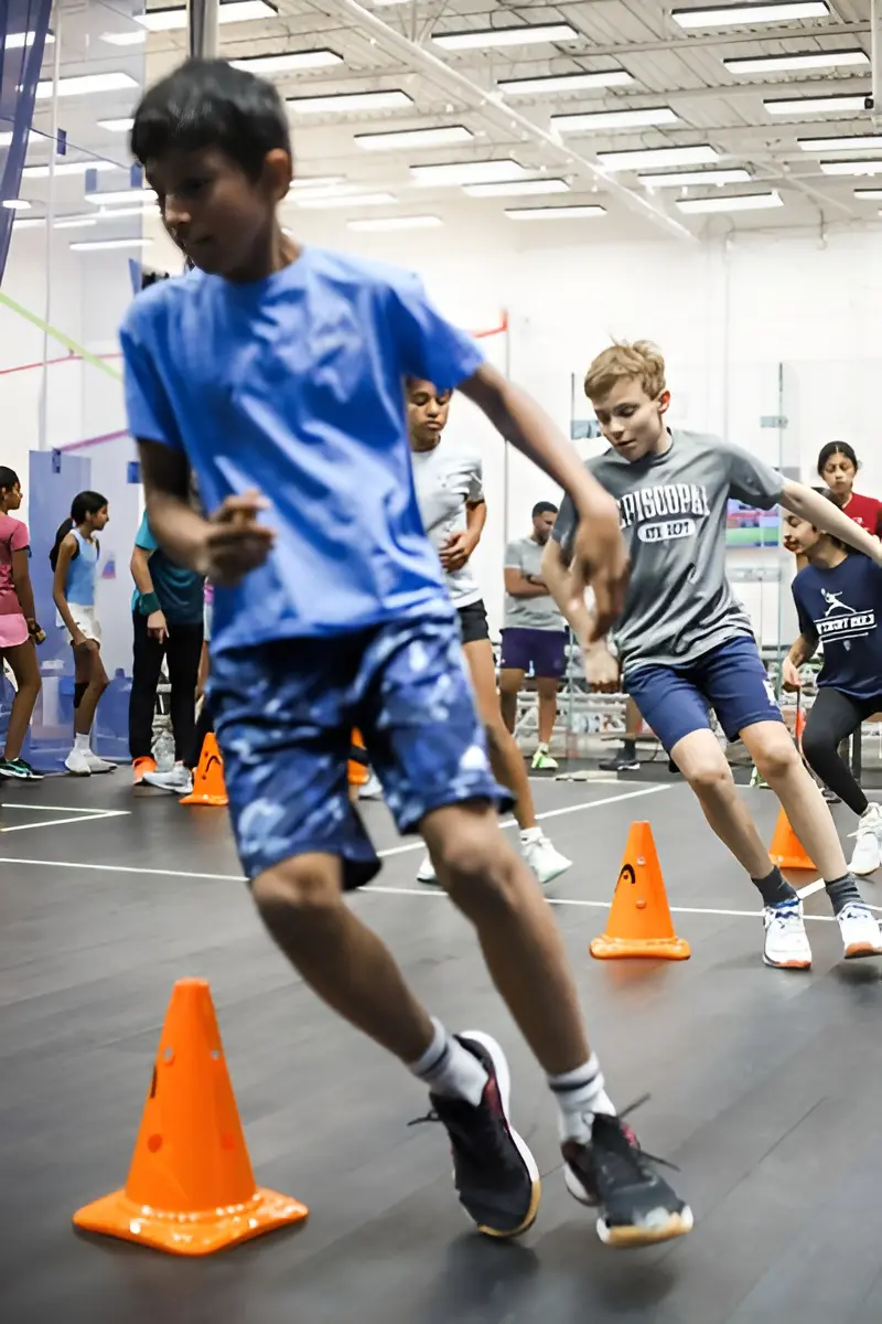 Children practicing agility drills with cones.