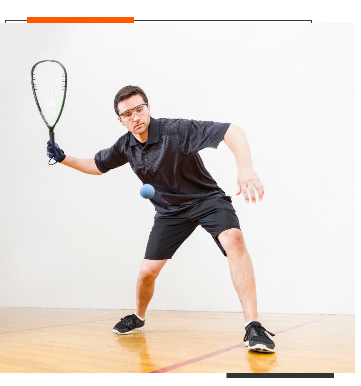 Man playing racquetball on wooden court.